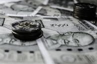 A detailed close-up of Indian currency notes and coins, highlighting financial themes.